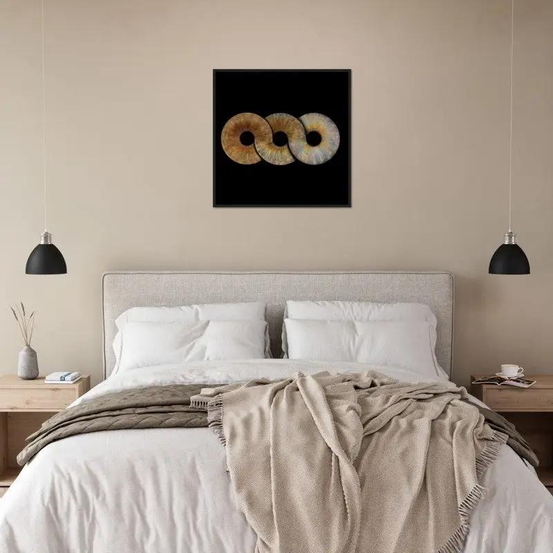 Trio iris black framed poster above a bed in cozy room