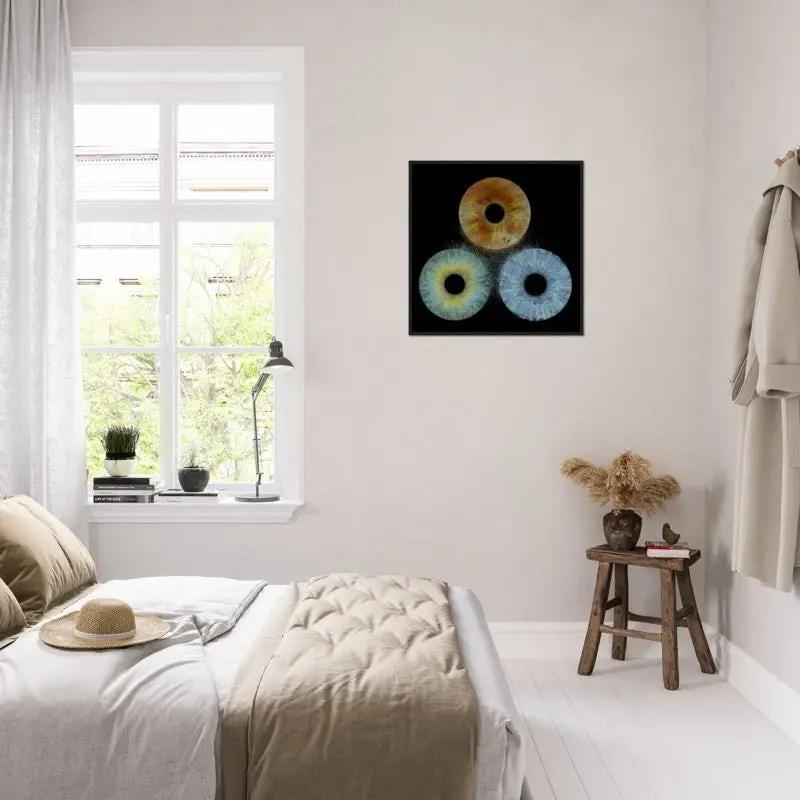 Trio iris poster framed in black in bright bedroom setting
