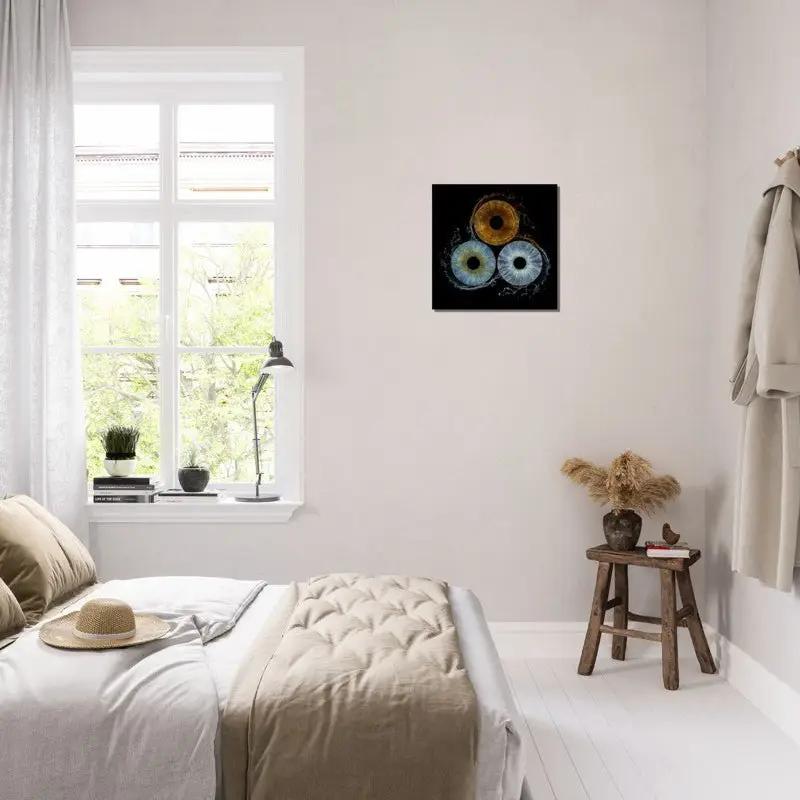 Trio iris canvas displayed in a bright bedroom